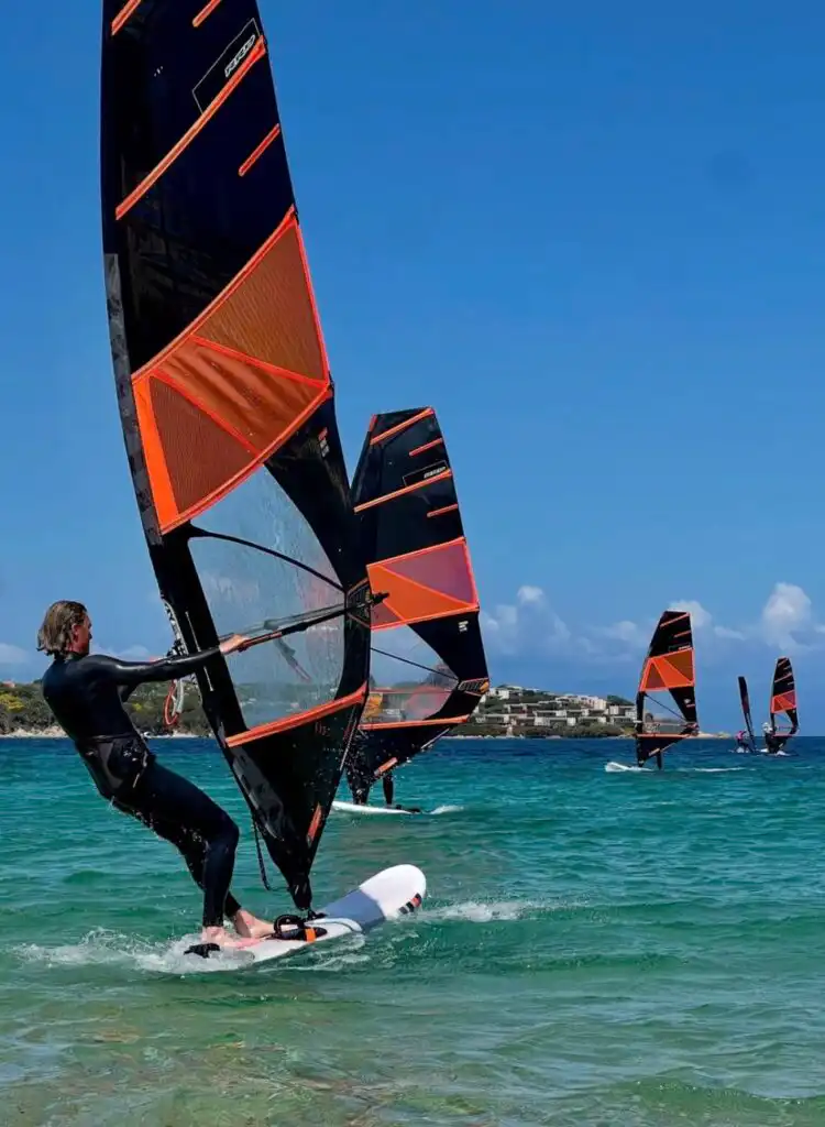 A group of windsurfers in Sardinia at Porto Pollo